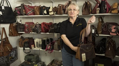 Linda Clifton shows handbags with a concealed carry pocket [Eline van Nes/Al Jazeera]