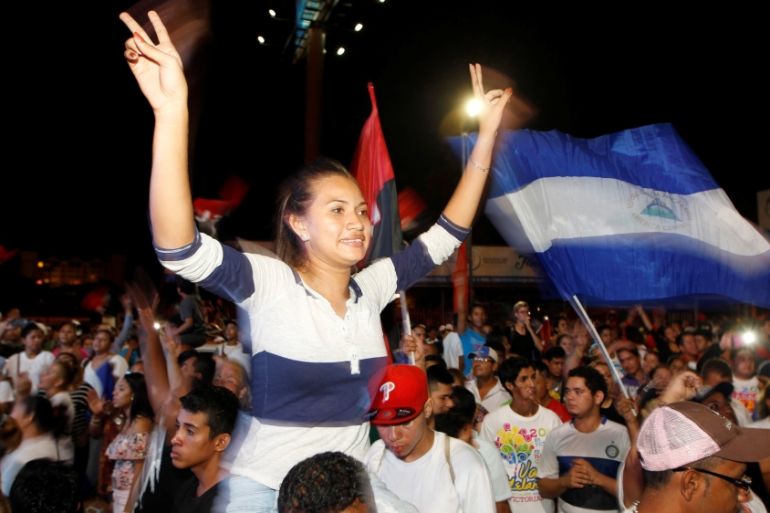 Supporters of Ortega and Murillo wave flags in Managua