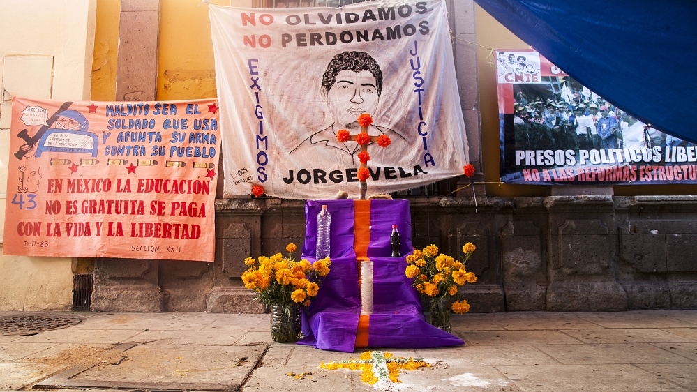 A block away from the Zocalo, an alter to Jorge Vela, a teacher killed during the protests this summer [Gabriela Campos/Al Jazeera]