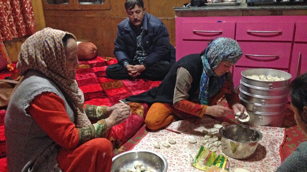 An Uighur feast is prepared at the home of Mohammad Abdullah [Sunaina Kumar/Al Jazeera] 