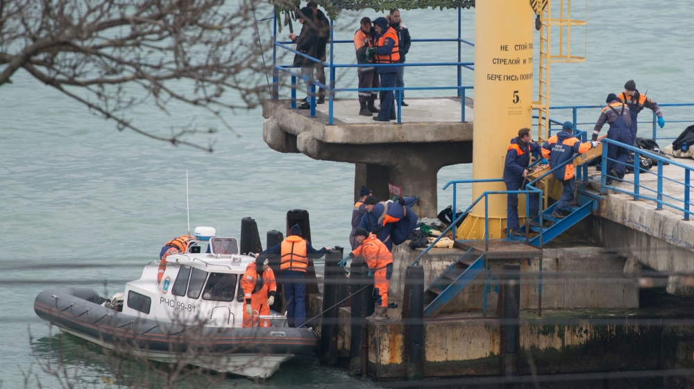 Rescuers unload fragments and remains of the Tu-154 plane crash near Sochi [EPA]