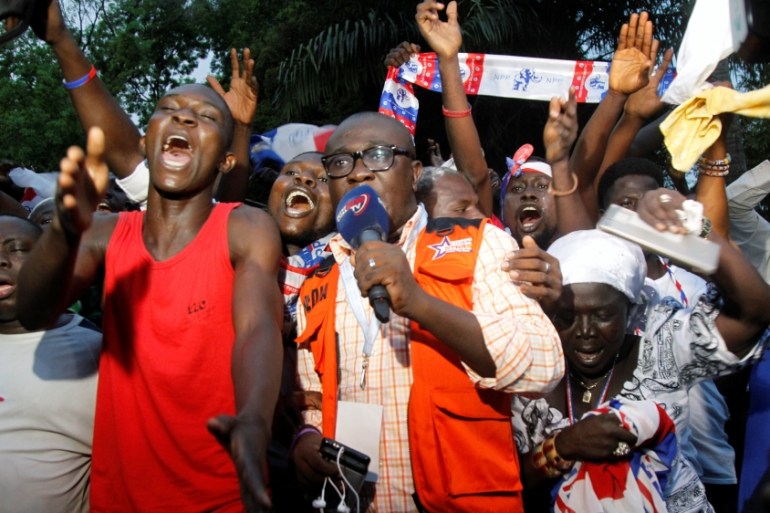 Supporters of Ghanaian presidential candidate Nana Akufo-Addo of the opposition New Patriotic Party (NPP) celebrate after his announced that he won the presidential election