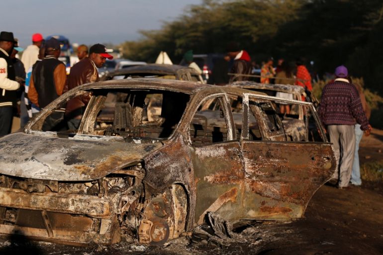 Relatives and civilians look at the wreckages of cars burnt after a fireball from an tanker engulfed several vehicles and killed several people, near the Rift Valley town of Naivasha,