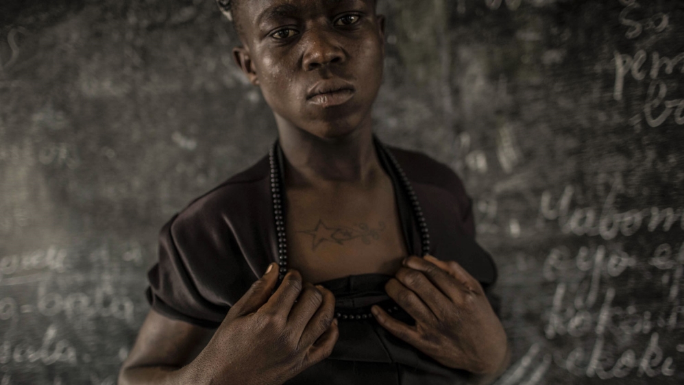 Cedrick Mukemwanga says he got his tattoos so that he could fit in with the other street kids [Francesca Volpi/Al Jazeera]