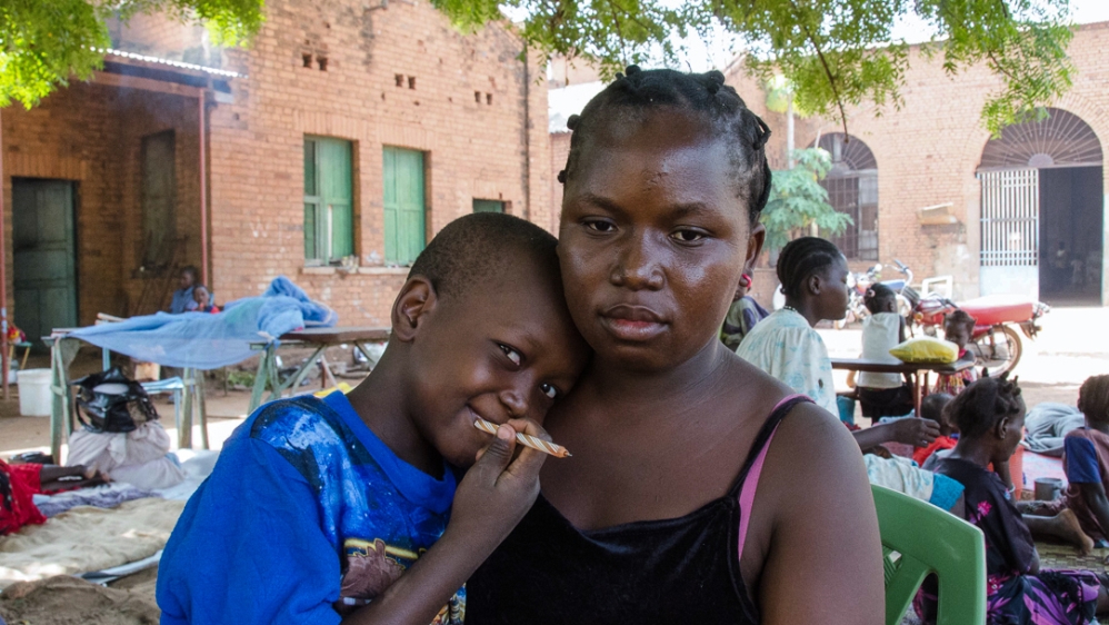 Mary Luka fled to St Mary’s Cathedral in Wau with her six-year-old son Alex Sadam after soldiers shot dead her husband and sexually assaulted her [Richard Nield/Al Jazeera] 