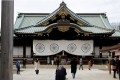 Visitors walk at the Yasukuni Shrine in Tokyo