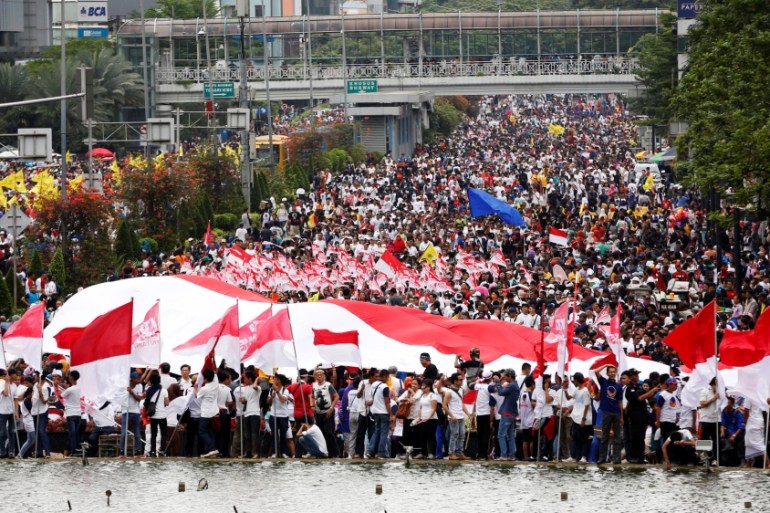 People attend a rally calling for national unity and tolerance in central Jakarta, Indonesia