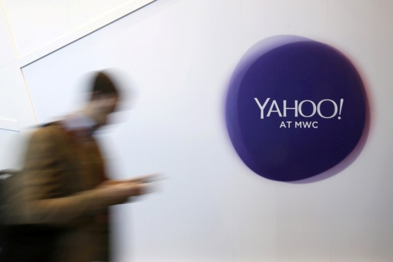 File photo of a man walking past a Yahoo logo during the Mobile World Congress in Barcelona
