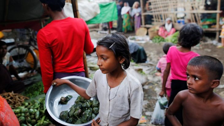 A girls sells food at the internally displaced persons camp for Rohingya people outside Sittwe in the state of Rakhine