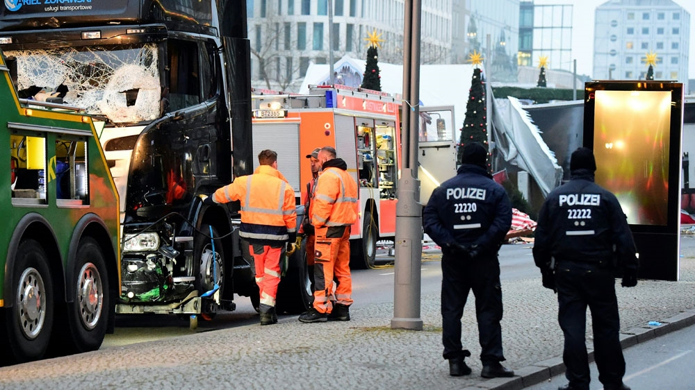 Forsenics and police examine the truck that crashed into a Christmas market crowd [AFP]