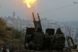 Free Syrian Army fighters fire an anti-aircraft weapon in a rebel-held area of Aleppo