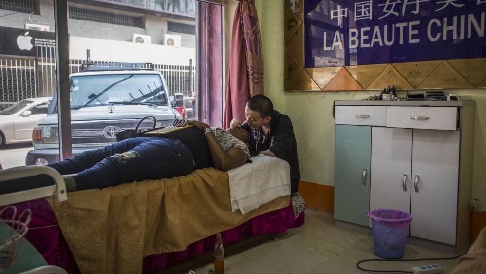 At a Chinese-run tattoo and beauty centre, residents of Kinshasa get their beauty treatment and body art [Francesca Volpi/Al Jazeera]