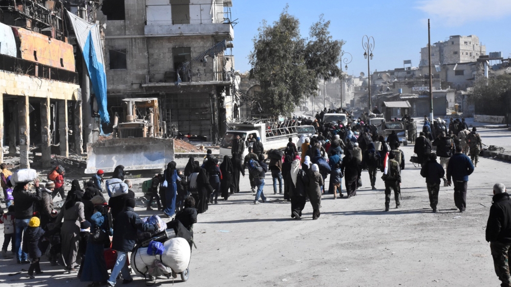A photo taken by Syrian state media shows civilians leaving rebel-held east Aleppo on December 8, 2016 [Reuters]