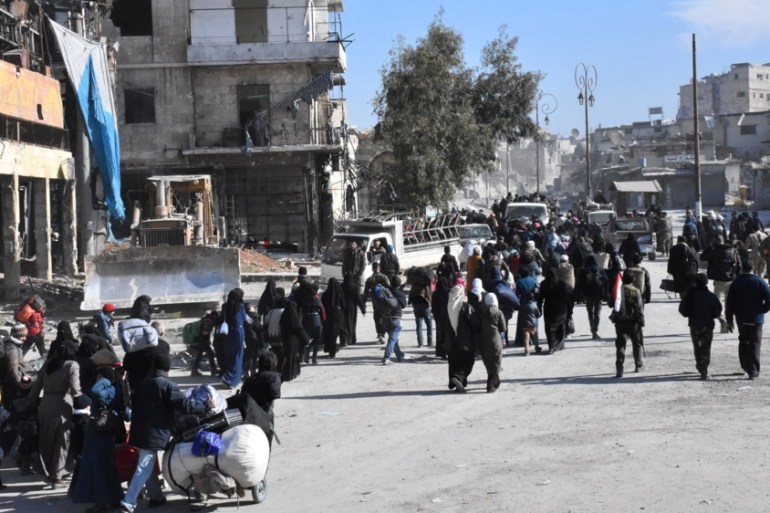 People leave the eastern districts of Aleppo, Syria