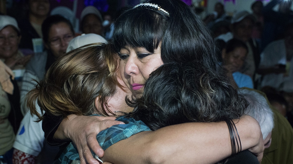 Amalia Aida Rodriguez hugs her sister and niece during her reunion after 37 years without news of each other. Amalia disappeared in Mexico when she was 22. She married and had children in Mexico, but she had no legal status, so she could not go back to Guatemala. Eventually her daughter got in contact with the Mesoamerican Migrant Movement who helped her find her family [Encarni Pindado/Al Jazeera] 