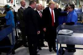 U.S. President-elect Donald Trump greets a worker as he tours a Carrier factory with Greg Hayes, CEO of United Technologies (L) in Indianapolis