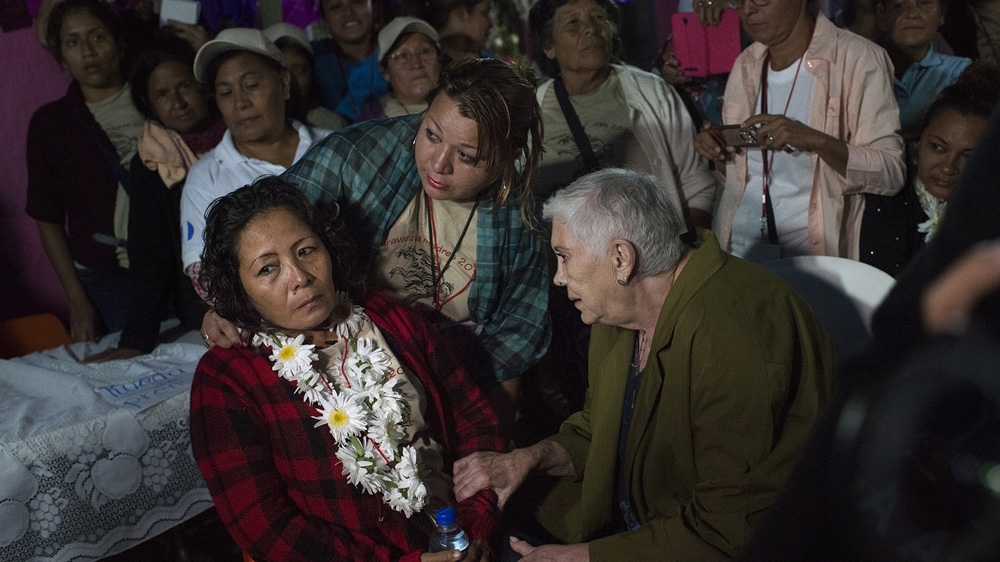 Norma Yanet Rodriguez fainted just before meeting her sister, Amalia Aida. Amalia had disappeared 37 years before. Aida had tried to contact her family but they had moved her letters were returned [Encarni Pindado/Al Jazeera]