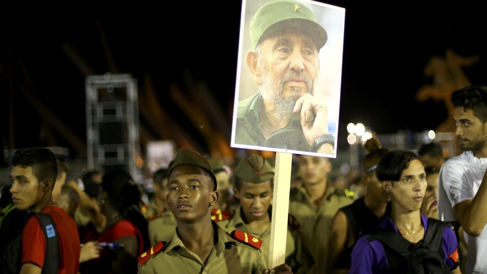 A cadet carries an image of former Cuban leader Fidel Castro [Alexandre Meneghini/Reuters]