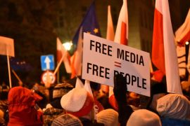 People demonstrate against new restrictions for media at the Polish Parliament in front of the Parliament building in Warsaw,