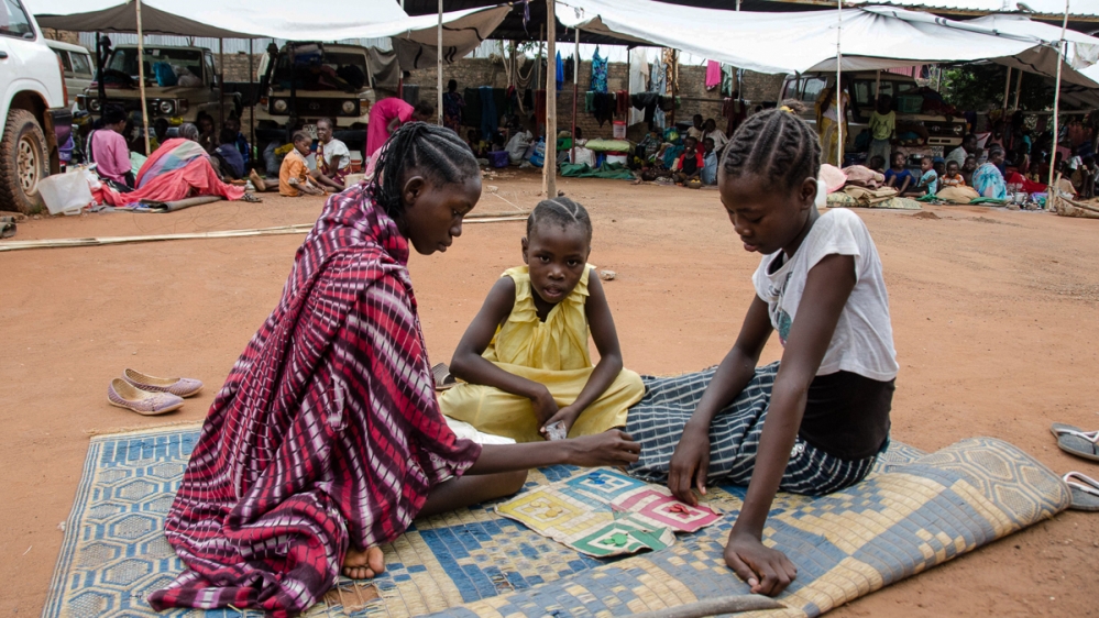 Children play in the Red Cross compound, Wau, where about 5,000 people sought refuge from the armed attacks on the town in just three days [Richard Nield/Al Jazeera]