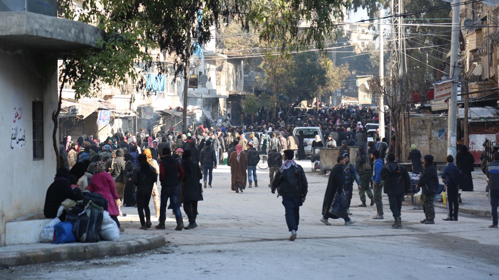 Families were lined up at the point of departure hoping to be evacuated from eastern Aleppo [Malek Al Shimale/Al Jazeera]