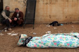 An Iraqi man mourns near the body of his son, who was killed during clashes in the Islamic State stronghold of Mosul, in al-Samah neighborhood, in Iraq