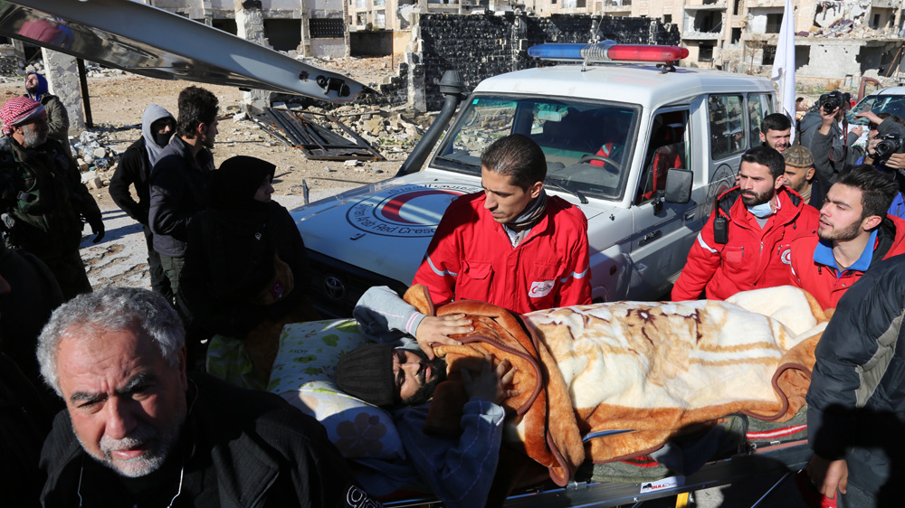 Medical workers evacuate an injured man from eastern Aleppo on Thursday December 15 [Malek al-Shimale/Al Jazeera]