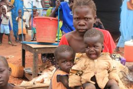 Christine Elia, 27, holds her twin sons at a displaced persons camp protected by U.N. peacekeepers in Wau, South Sudan