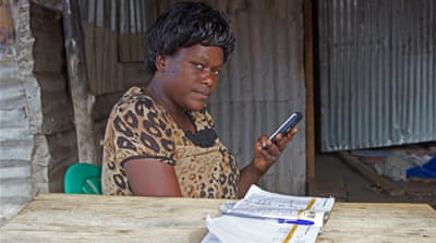 Florence Namatende, a Ugandan woman moved up north to set up a mobile money business in Nyumanzi market [Tendai Marima/Al Jazeera]