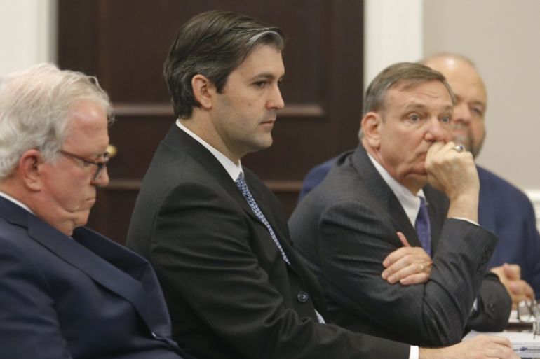 Former North Charleston police officer Michael Slager sits with his defense team at the Charleston County court in Charleston