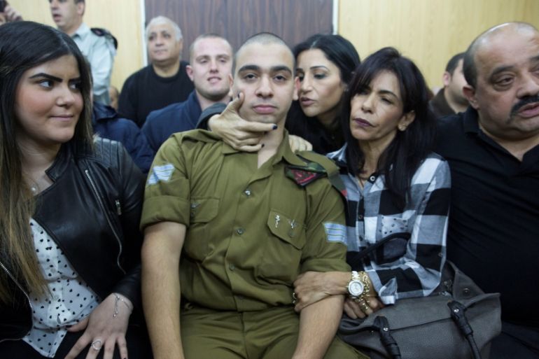 Israeli soldier Elor Azaria, who is charged with manslaughter by the Israeli military, sits to hear his verdict in a military court in Tel Aviv, Israel