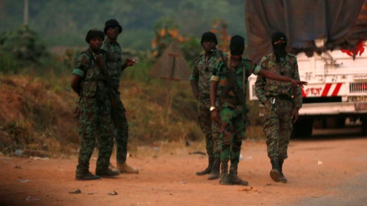 Mutinous soldiers who have taken control of Bouake stand at a checkpoint in Bouake