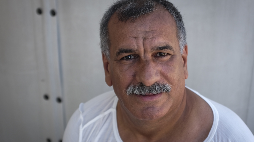 Sixty-year-old Mansour Ali Nasir, from Algeria, swam for seven hours after the small boat he had boarded earlier that night to cross the Aegean sank. He is one of six survivors who were rescued two kilometres off the coast of Lesbos on the morning of July 13, 2015 [Fahrinisa Oswald/Al Jazeera]