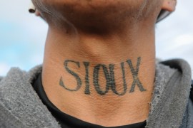 A man from the Lakota Sioux tribe with a Native American tattoo on his neck poses for a photograph during a protest against plans to pass the Dakota Access pipeline near the Standing Rock Indian Reser