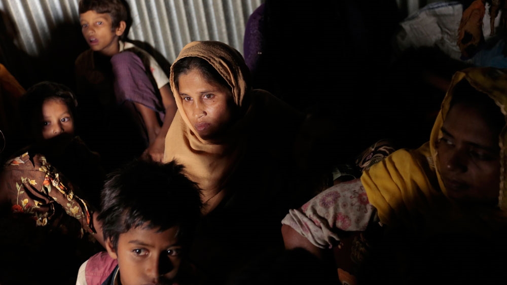 
Rohingya from Myanmar who crossed over to Bangladesh, huddle in a room at an unregistered refugee camp in Teknaf, near Cox's Bazar [AP]
