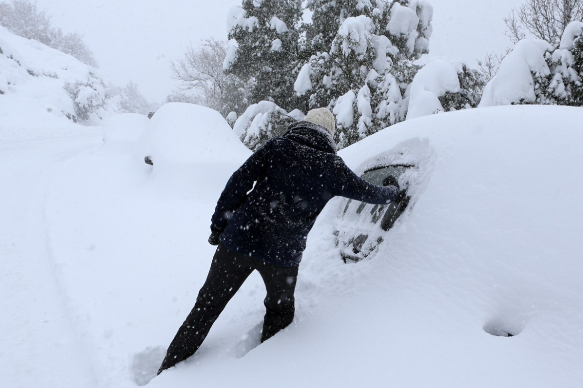 Doing the best to dig out her snowed covered car in Corte, Corsica