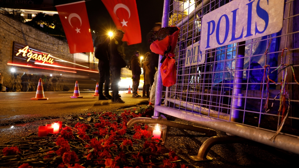 Flowers are placed in front of a police barrier near the entrance of Reina nightclub [Umit Bektas/Reuters]