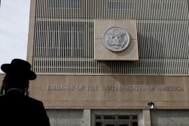 An ultra-Orthodox Jewish man stands in front of the U.S Embassy in Tel Aviv