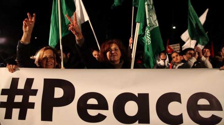 Greek Cypriots and Turkish Cypriots take part in a peace rally