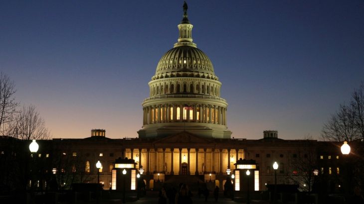 The U.S. Capitol Building is lit at sunset in Washington