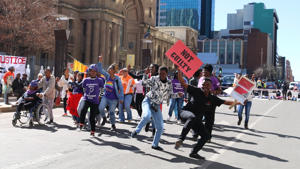 
Activists with Sisonke, a national sex worker rights movement, protest against gender-based violence outside the High Court in Johannesburg last July [Caelainn Hogan/Al Jazeera]
