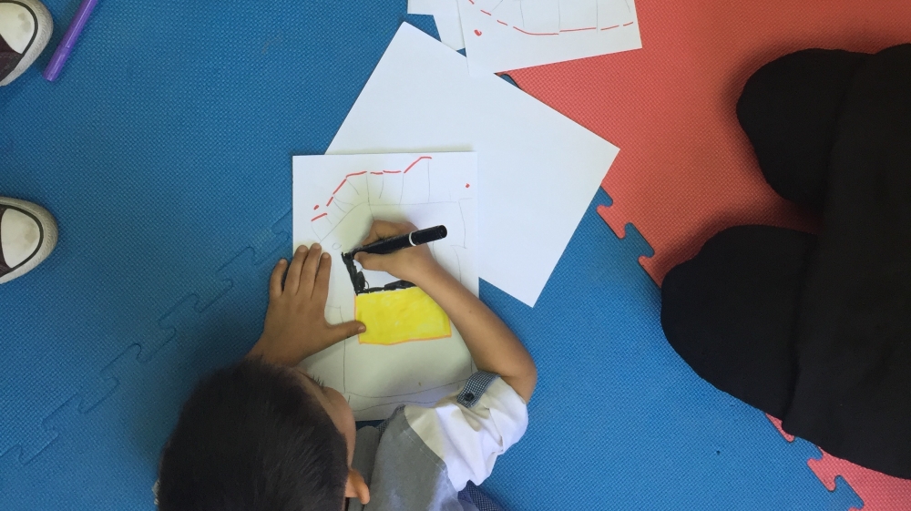 The aim of the art therapy sessions is to help children to overcome symptoms such as anxiety, anger and behavioural difficulties [Dania Fawaz/Al Jazeera]