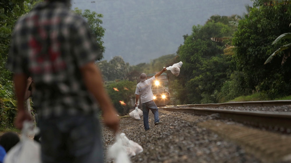 Volunteers from a group called 'Las Patronas' hold bags with food and water for immigrants on their way to the border with the United States, at Amatlan de los Reyes [Daniel Becerril/Reuters] 