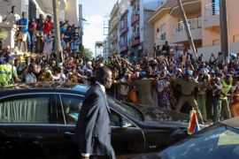 Hundreds of well-wishers cheer and wave as Gambia President Adama Barrow is driven after his inauguration ceremony at the Gambian embassy in Dakar