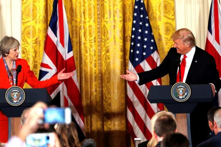 British Prime Minister May and U.S. President Trump gesture towards each other as they hold a joint news conference at the White House in Washington