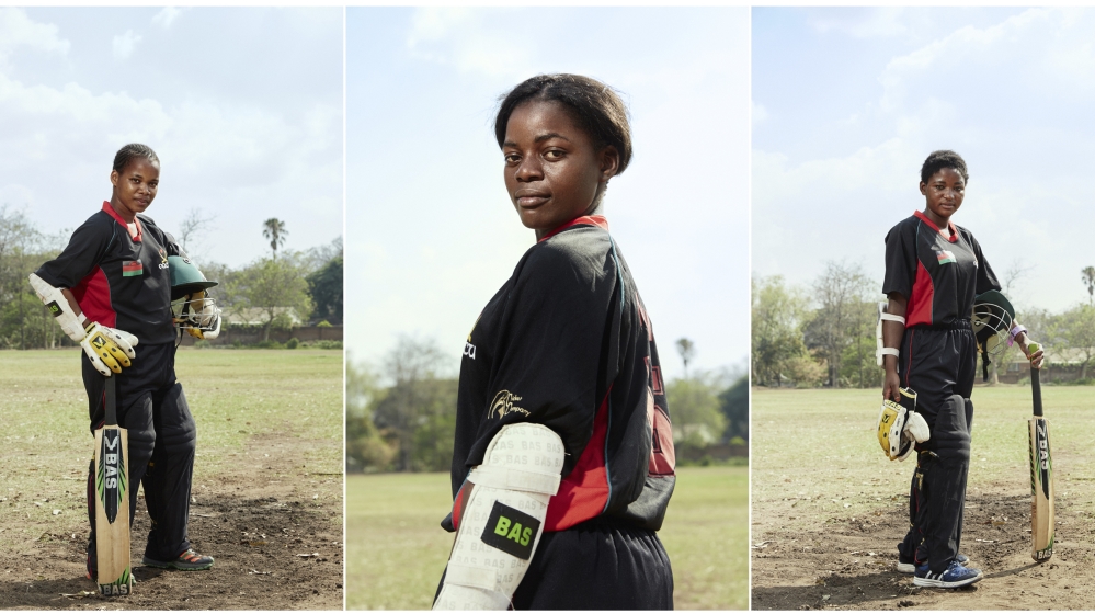 From Left to Right: Vice Captain Mary Mavuka, 18, batsman Dalitso Ndipo, 19, and Captain Shahida Hussein, 17, pose on the pitch of their training grounds [Julia Gunther/Al Jazeera]