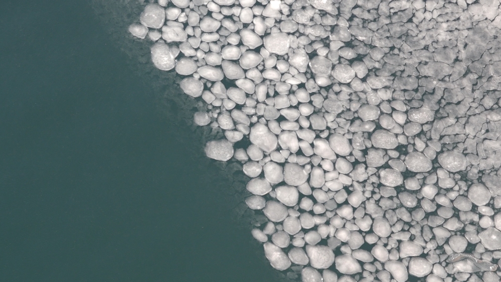 As the snow and ice hit the water they form what is known as pancake ice [Tarek Bazley/Al Jazeera]