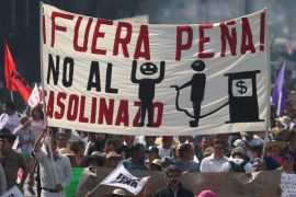 Protesters march during a demonstration against the rising prices of gasoline enforced by the Mexican government at downtown in Mexico City