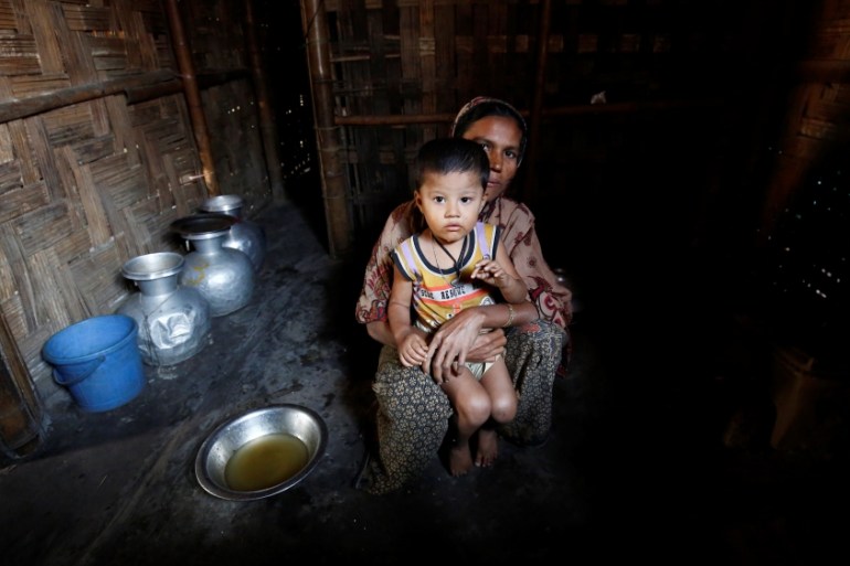 A Rohingya Muslim woman poses for a photograph with her son at the Leda unregistered Rohingya Refugee Camp in Teknaf near Cox’s Bazar