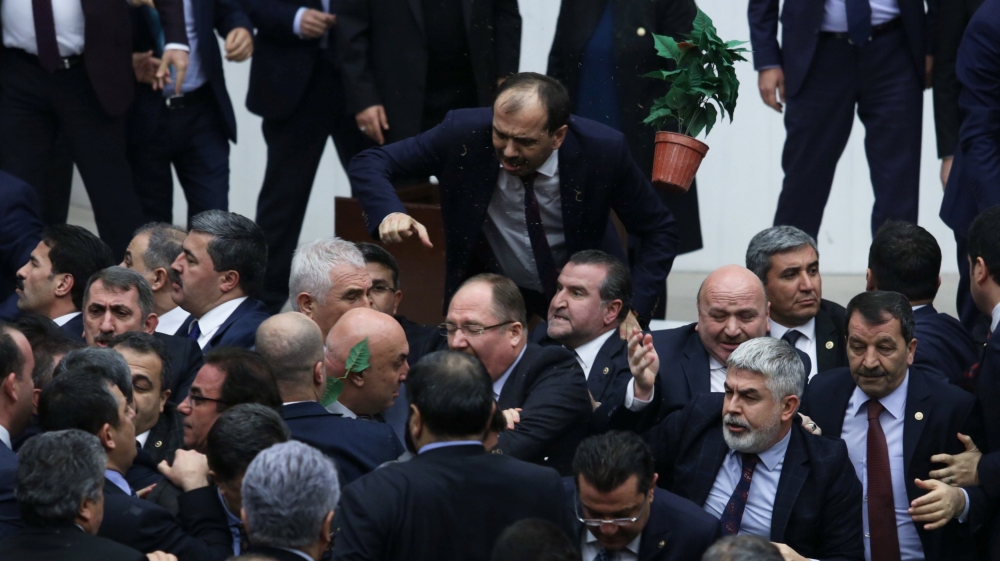 Politicians from the ruling AKP party and the main opposition CHP scuffle during a debate on the proposed constitutional changes [Reuters]